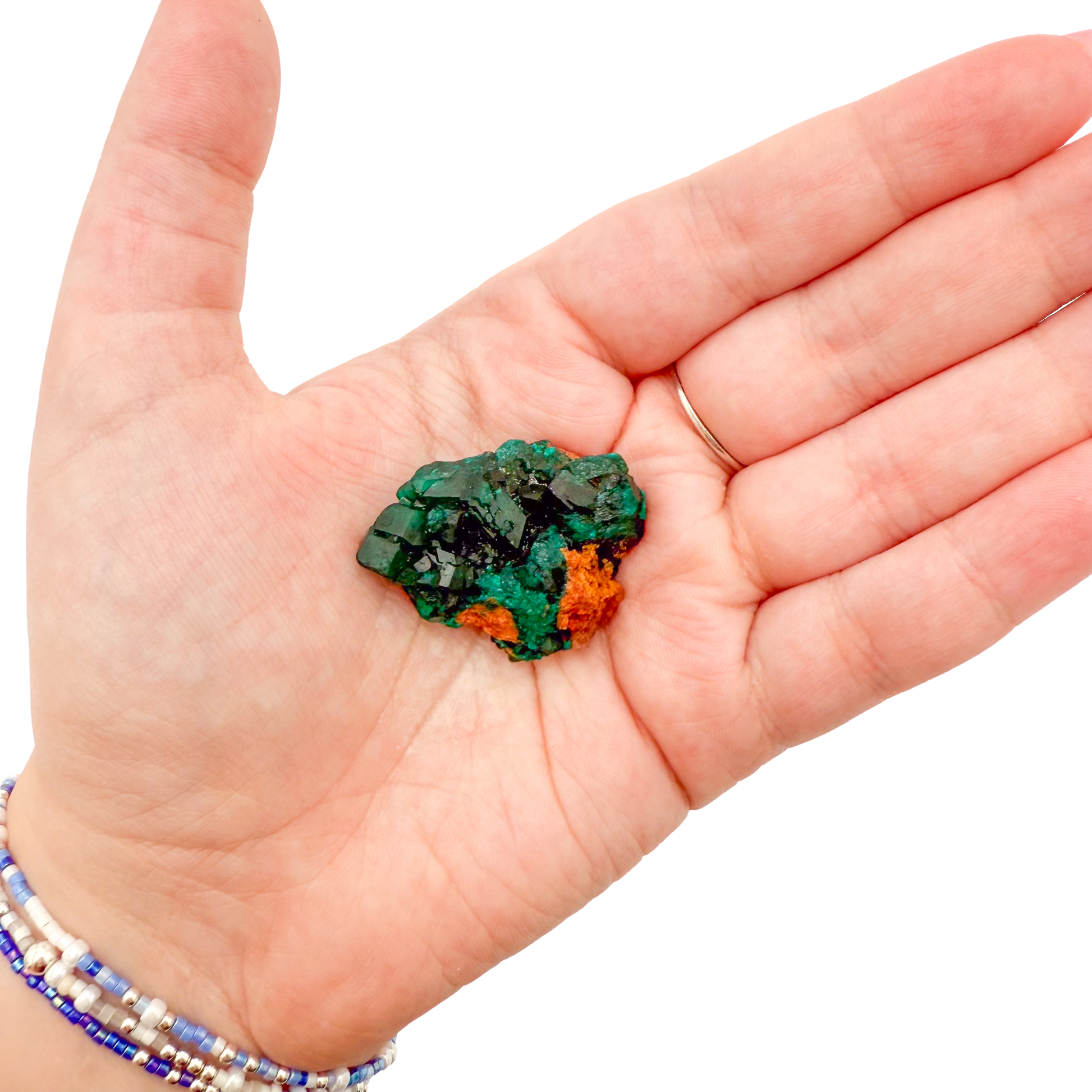 Dioptase crystal specimen from the Republic of the Congo held in hand for scale, deep emerald-green druzy, specimen 13