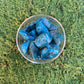 Back view of Grade AA Apatite tumbled stone showing natural surface