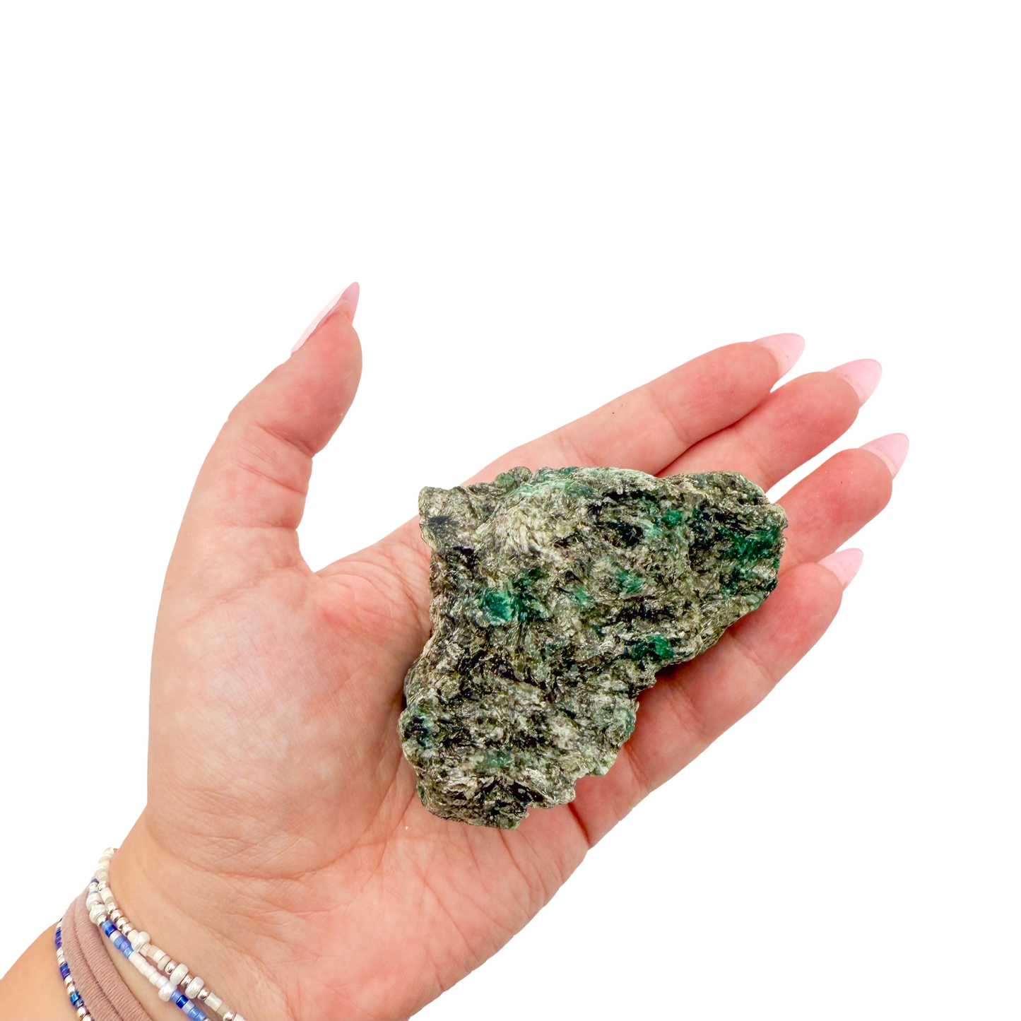 Raw emerald specimen from Zimbabwe held in hand to show scale