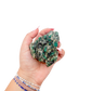 Raw emerald specimen from Zimbabwe held in hand to show scale