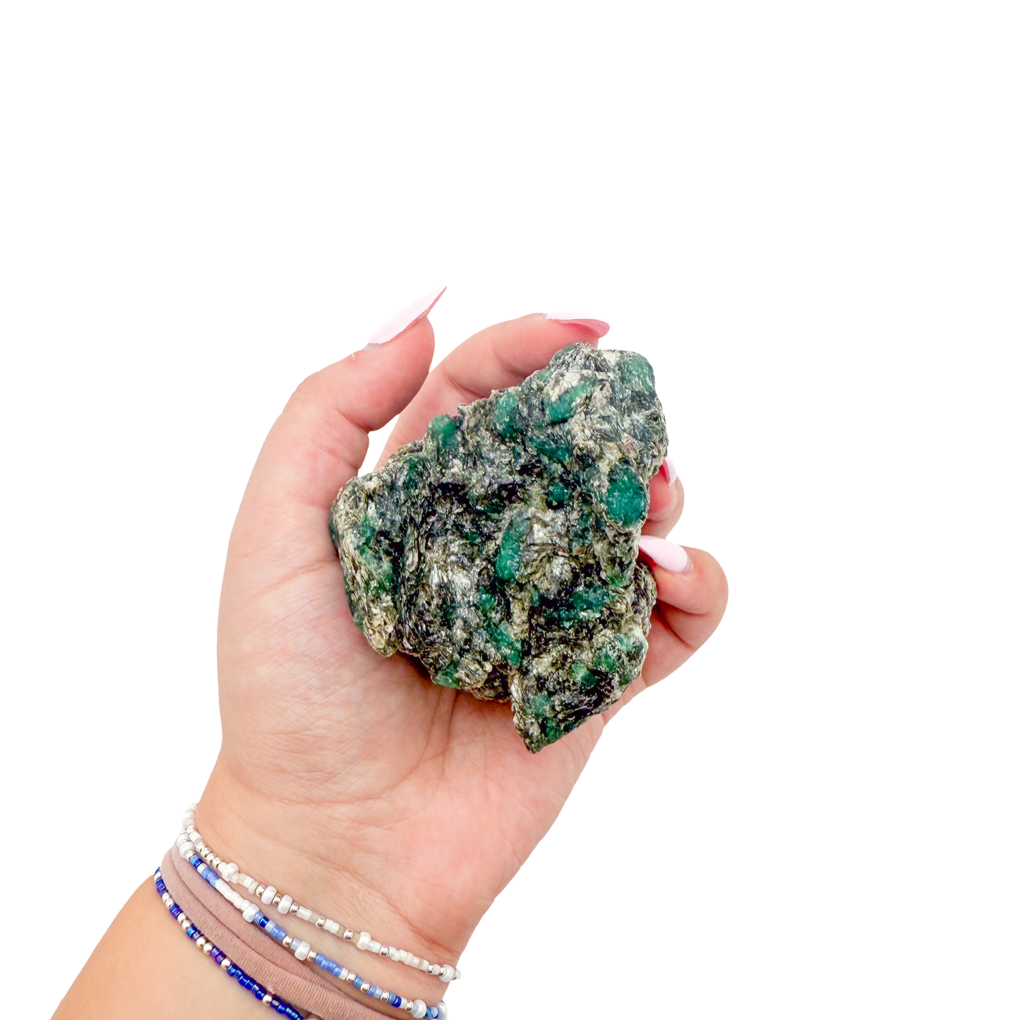 Raw emerald specimen from Zimbabwe held in hand to show scale