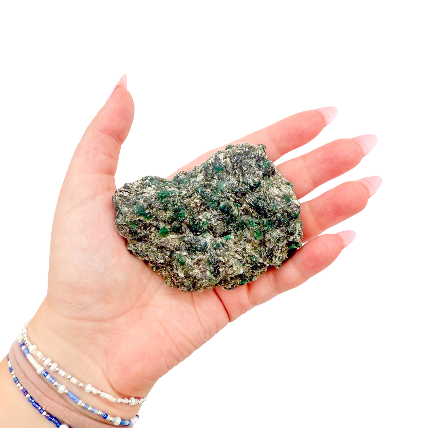 Raw emerald specimen from Zimbabwe held in hand to show scale