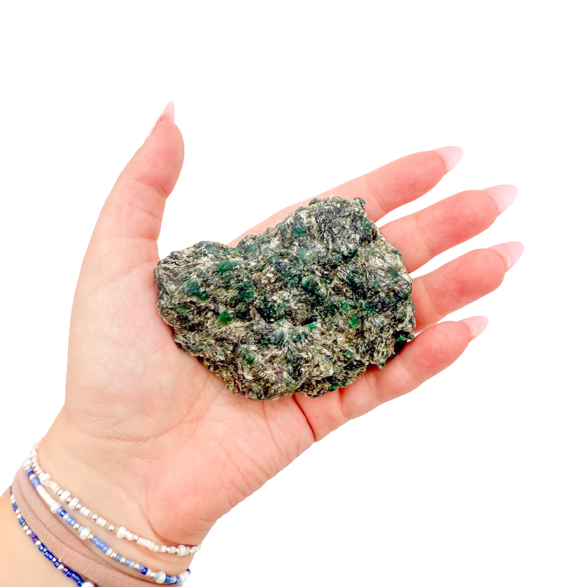 Raw emerald specimen from Zimbabwe held in hand to show scale
