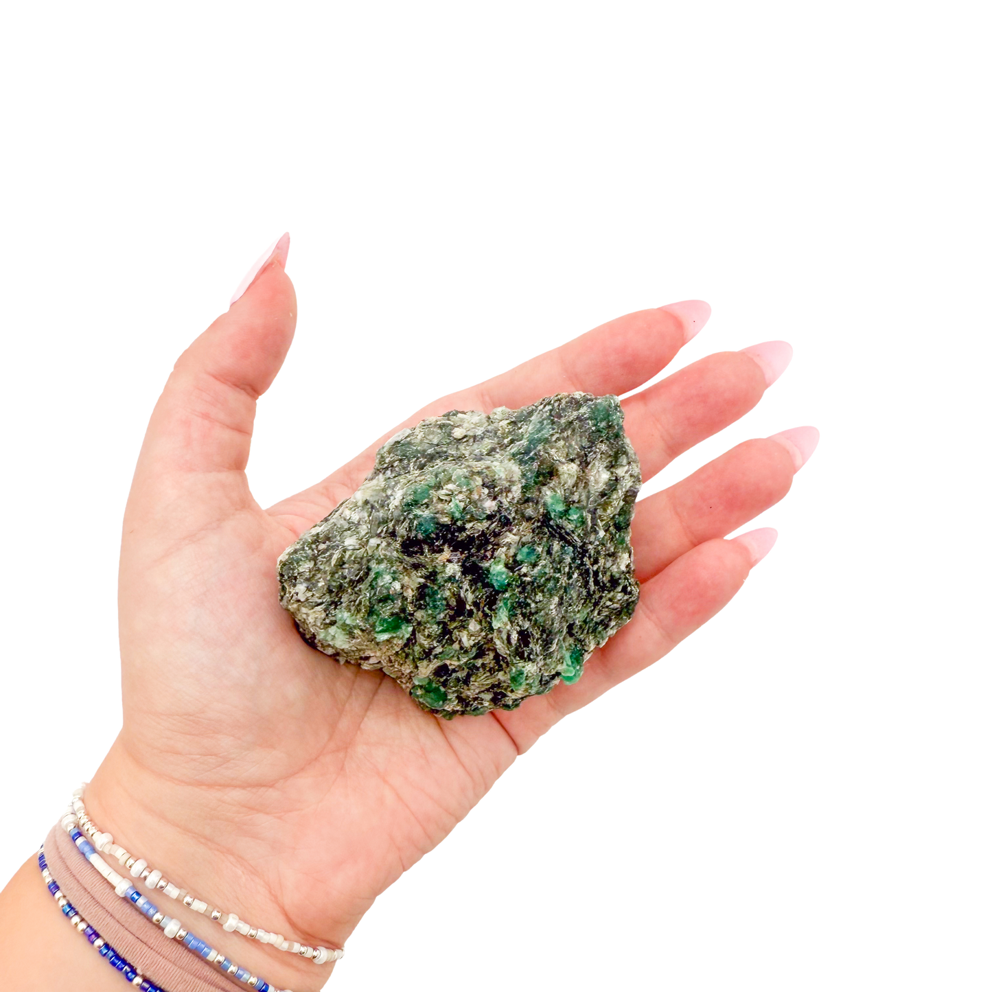 Raw emerald specimen from Zimbabwe held in hand to show scale