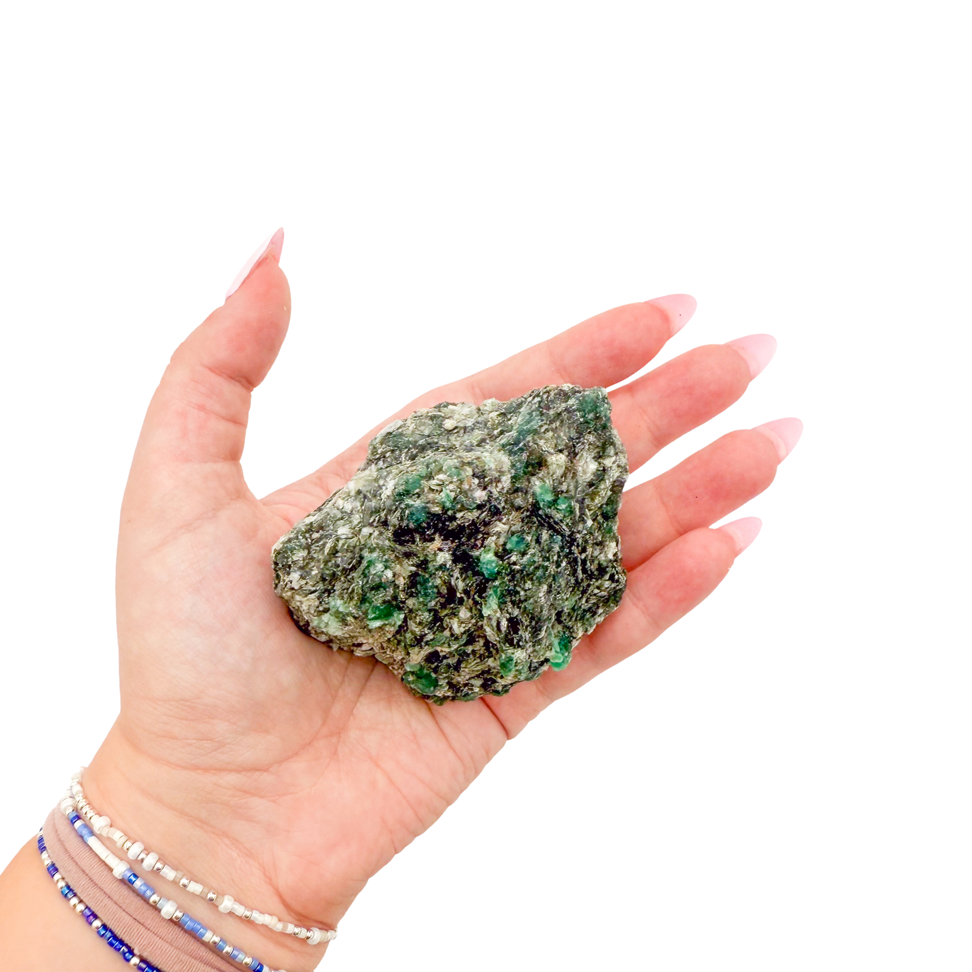 Raw emerald specimen from Zimbabwe held in hand to show scale