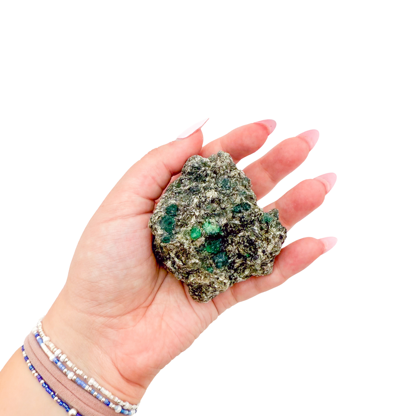 Raw emerald specimen from Zimbabwe held in hand to show scale
