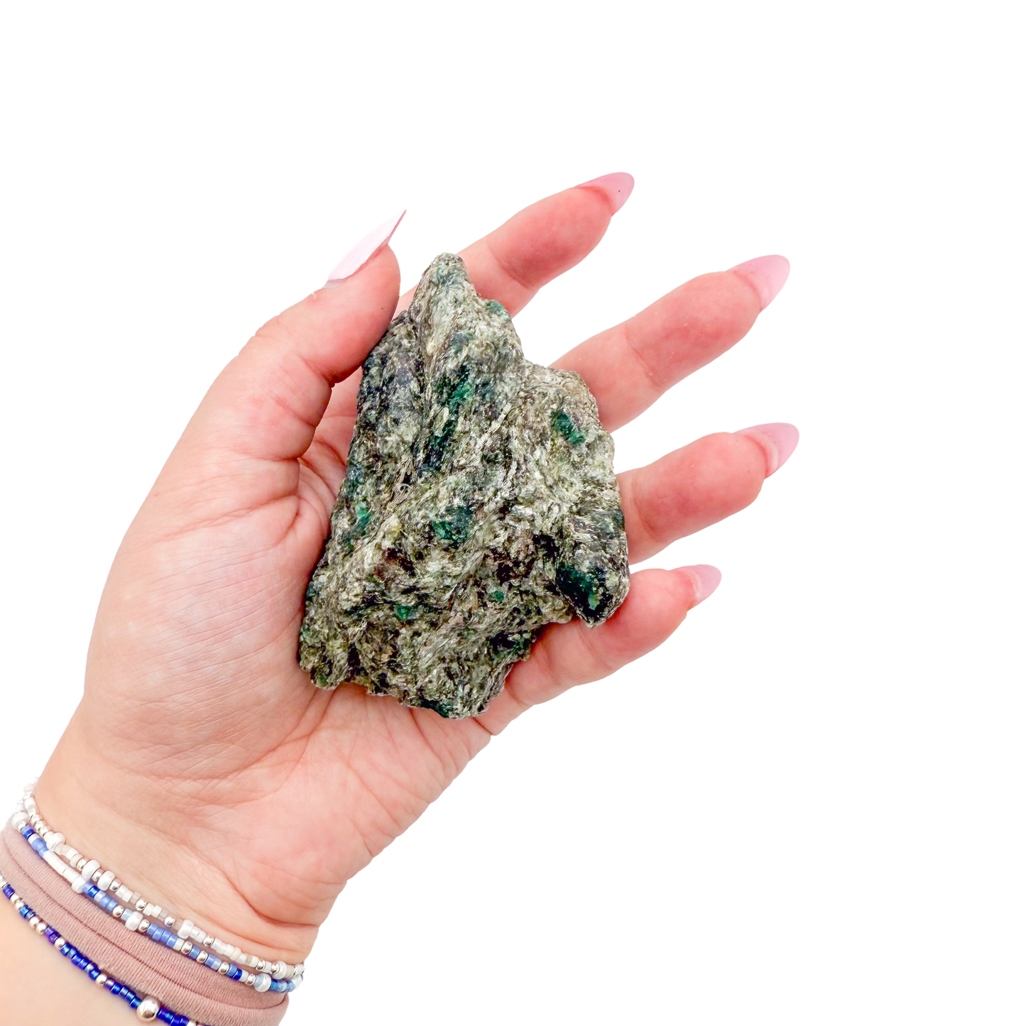 Raw emerald specimen from Zimbabwe held in hand to show scale
