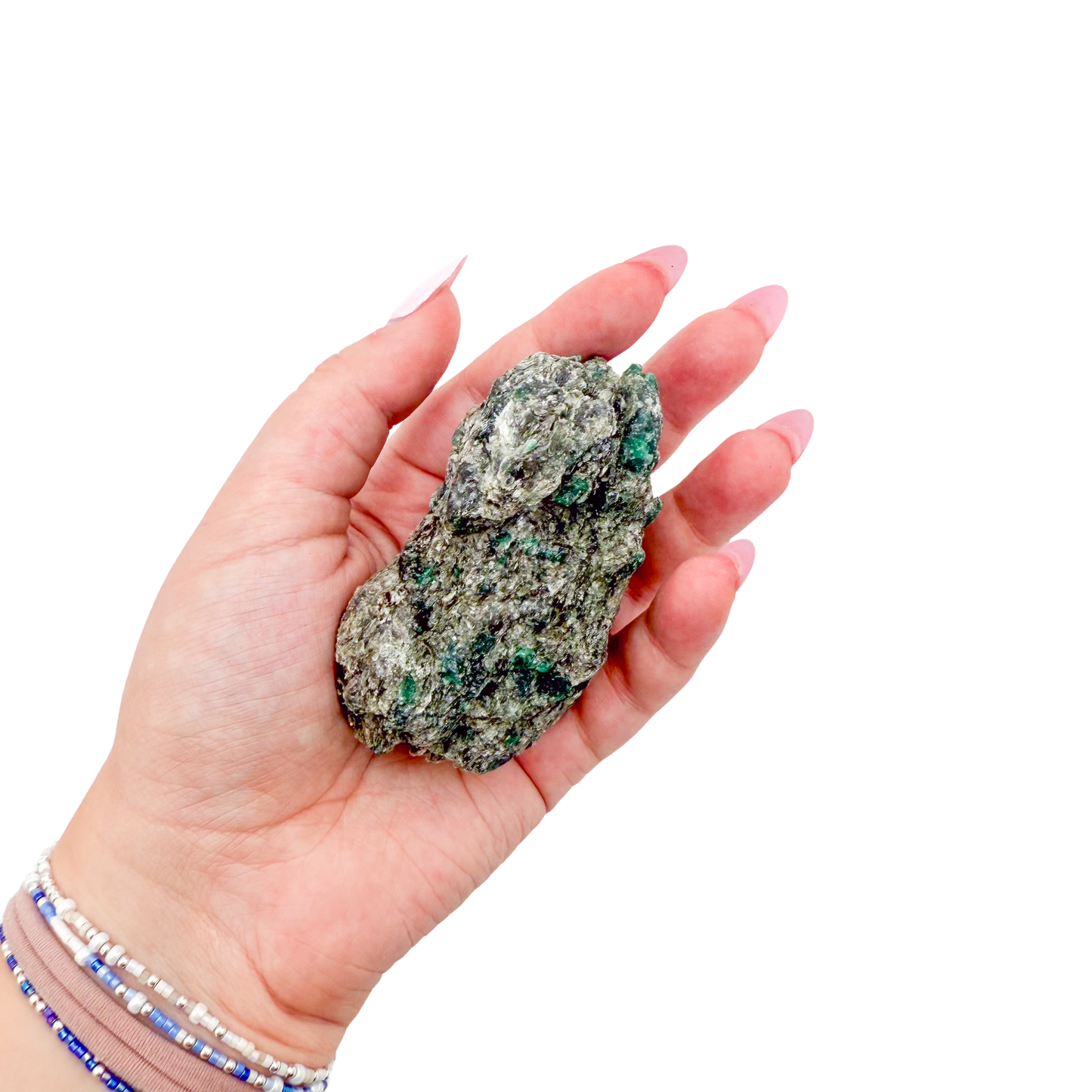 Raw emerald specimen from Zimbabwe held in hand to show scale