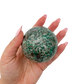 Emerald sphere no. 3 held in an open hand, showing the true scale of this 2.57 inch, 426 gram orb.