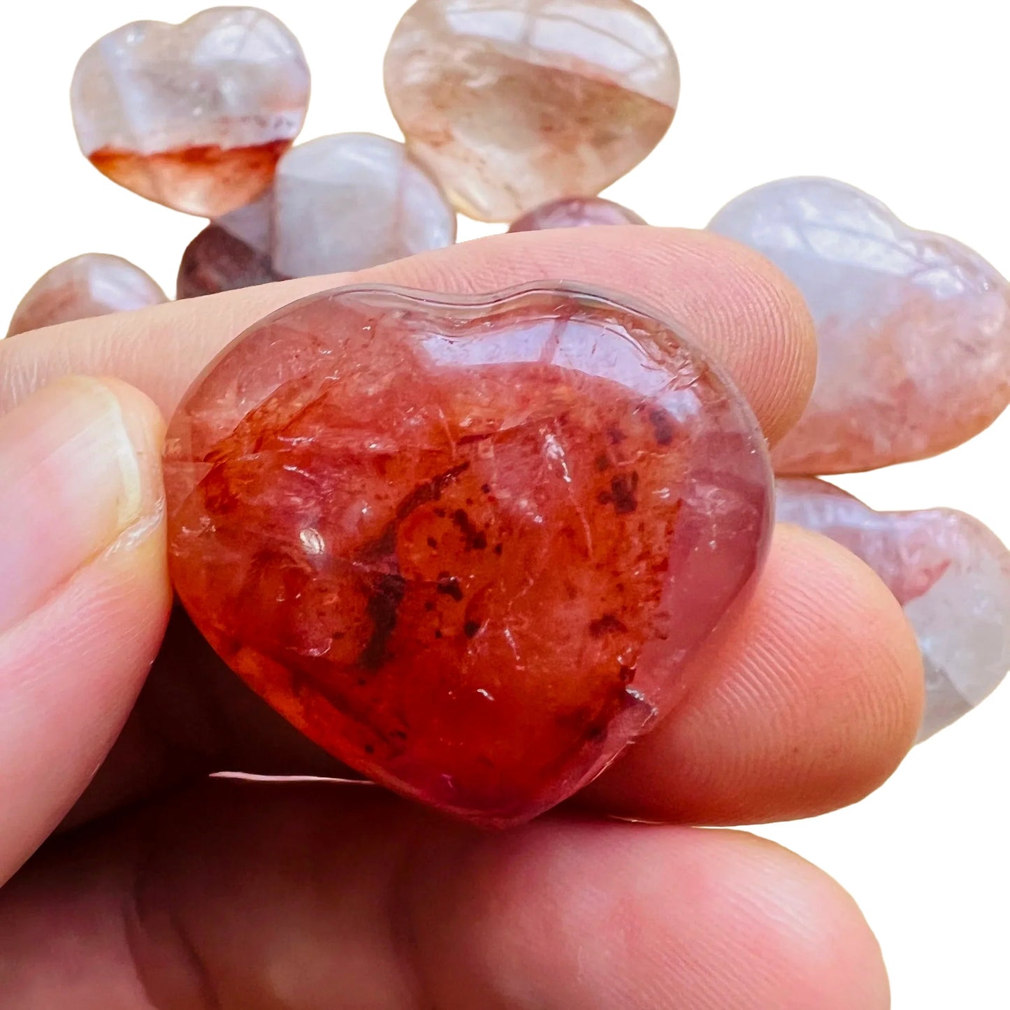 Held in hand is a Fire Quartz stone, with character of the piece on display.