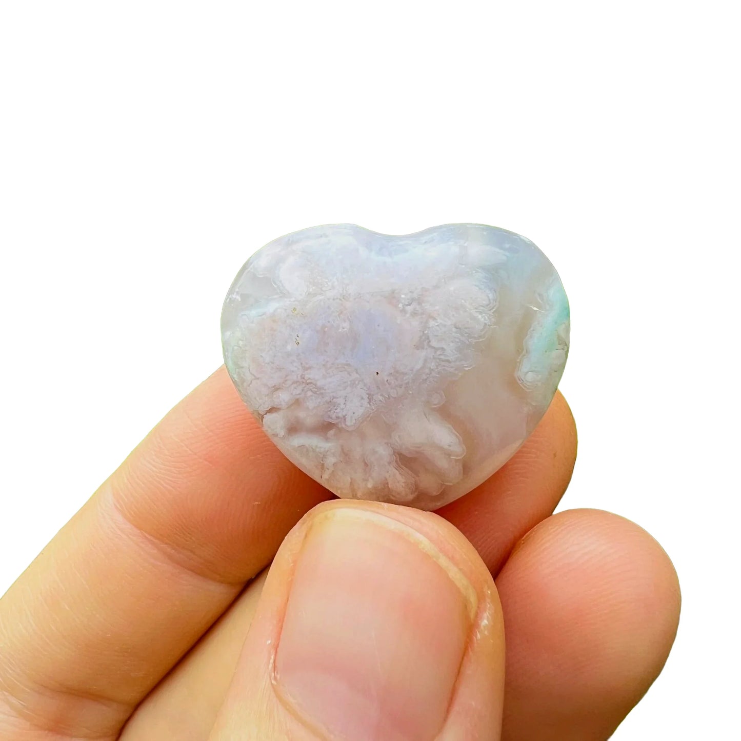 Edge view of Flower Agate polished heart, from Madagascar, carried for Love and Emotional Healing.