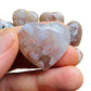 Hand-held view of a Flower Agate polished heart, from Madagascar.