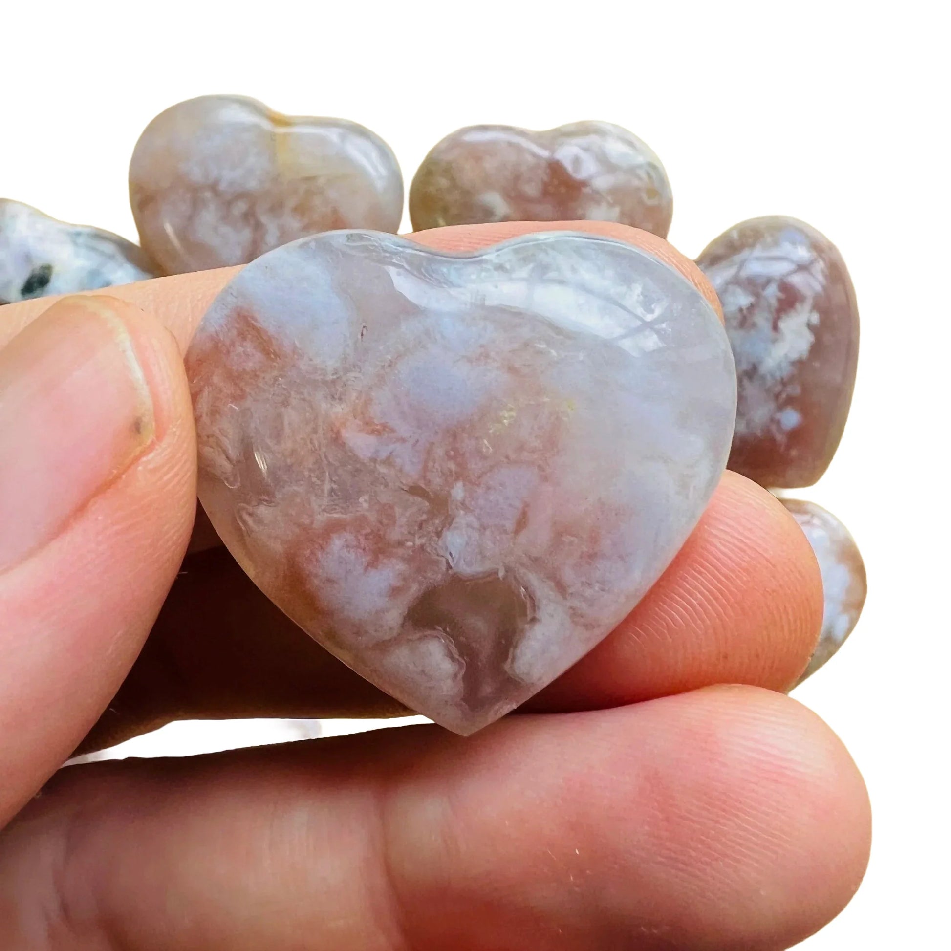 Hand-held view of a Flower Agate polished heart, from Madagascar.
