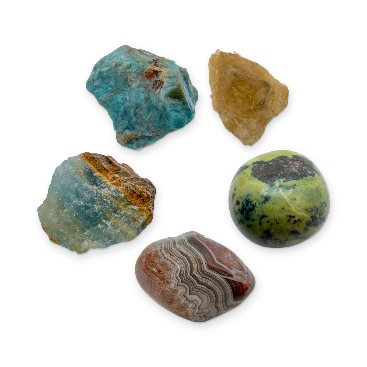 Gemini Crystal Kit: blue apatite, natural citrine, serpentine, crazy lace agate and blue onyx, shown together on white