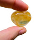 Edge-on view of Grade AA Golden Healer polished heart, sourced from Alaotra-Mangoro, Madagascar, showing natural texture.