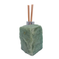 Green aventurine reed oil diffuser rear view, untreated sage green stone surface