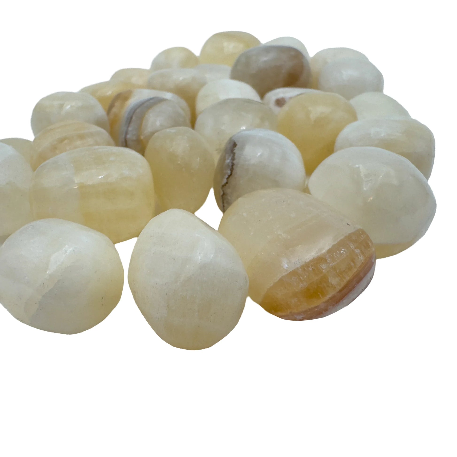 Bulk Honey Calcite tumbled stones piled together, warm golden crystals