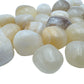 Pile of polished Honey Calcite tumbled stones, AA grade from Peru