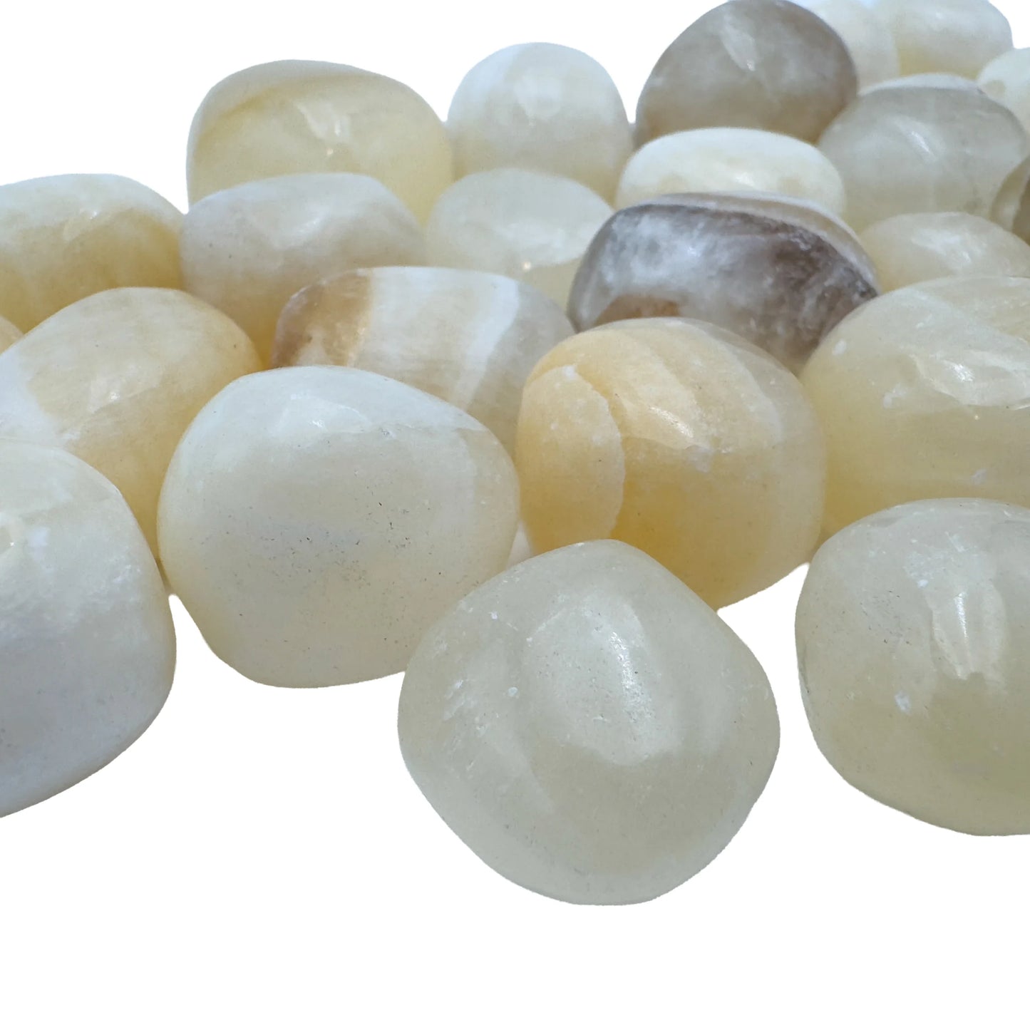 Pile of polished Honey Calcite tumbled stones, AA grade from Peru