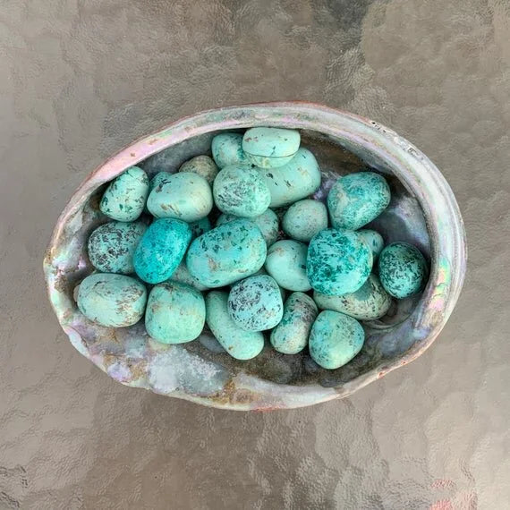 Detail shot of Grade A Chrysocolla tumbled stone under natural light