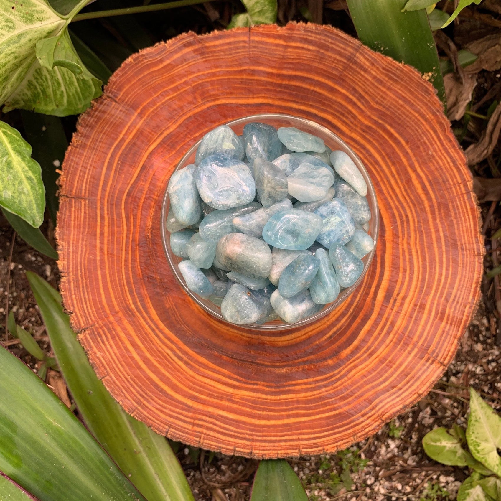 Lifestyle context of Aquamarine tumbled stone, from Minas Gerais, Brazil, traditionally used for Confidence, captured in natural daylight.