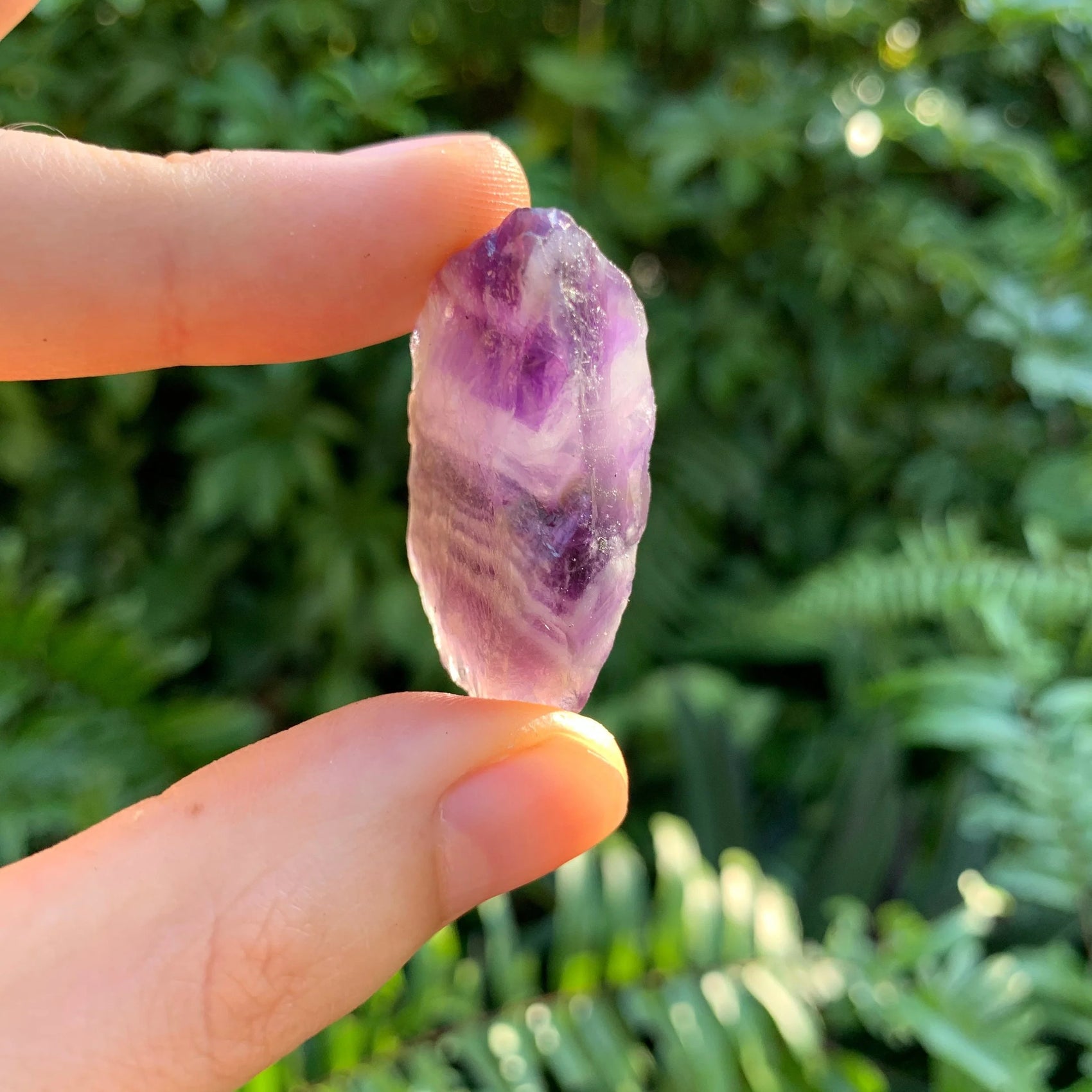 Profile shot of Grade AA Chevron Amethyst raw stone, showing honest grain.
