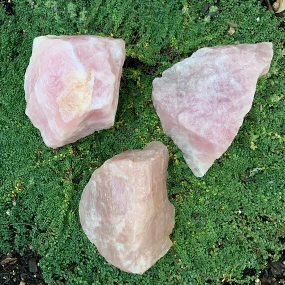 Underside view of Rose Quartz raw stone, linked to Love, showing subtle veining.