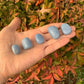 Display context of Angelite tumbled stone, from Huarochirí, Peru, traditionally used for Stress Relief, captured in natural daylight.