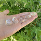 Alternate angle of Grade AAA Clear Quartz tumbled stone showing overall shape