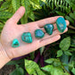 Back view of Grade AA Malachite tumbled stone showing natural surface