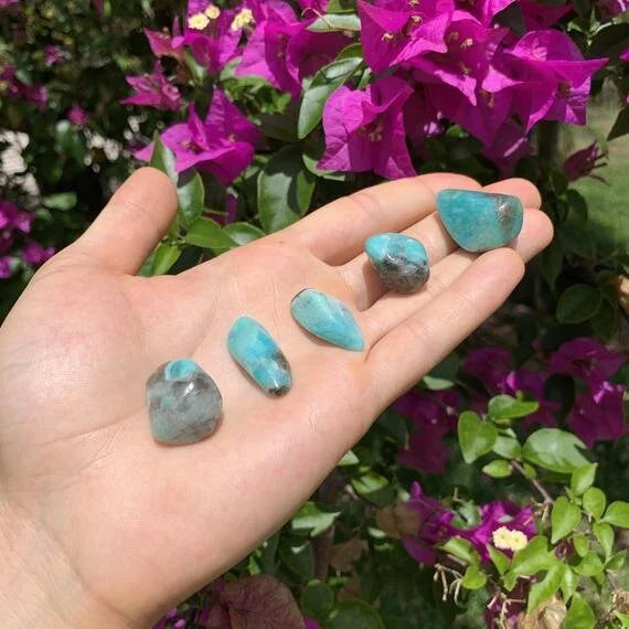 Detail shot of Grade AA Amazonite tumbled stone under natural light