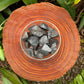 Natural light view of a Hematite raw stone held against natural backdrop, from Brazil.