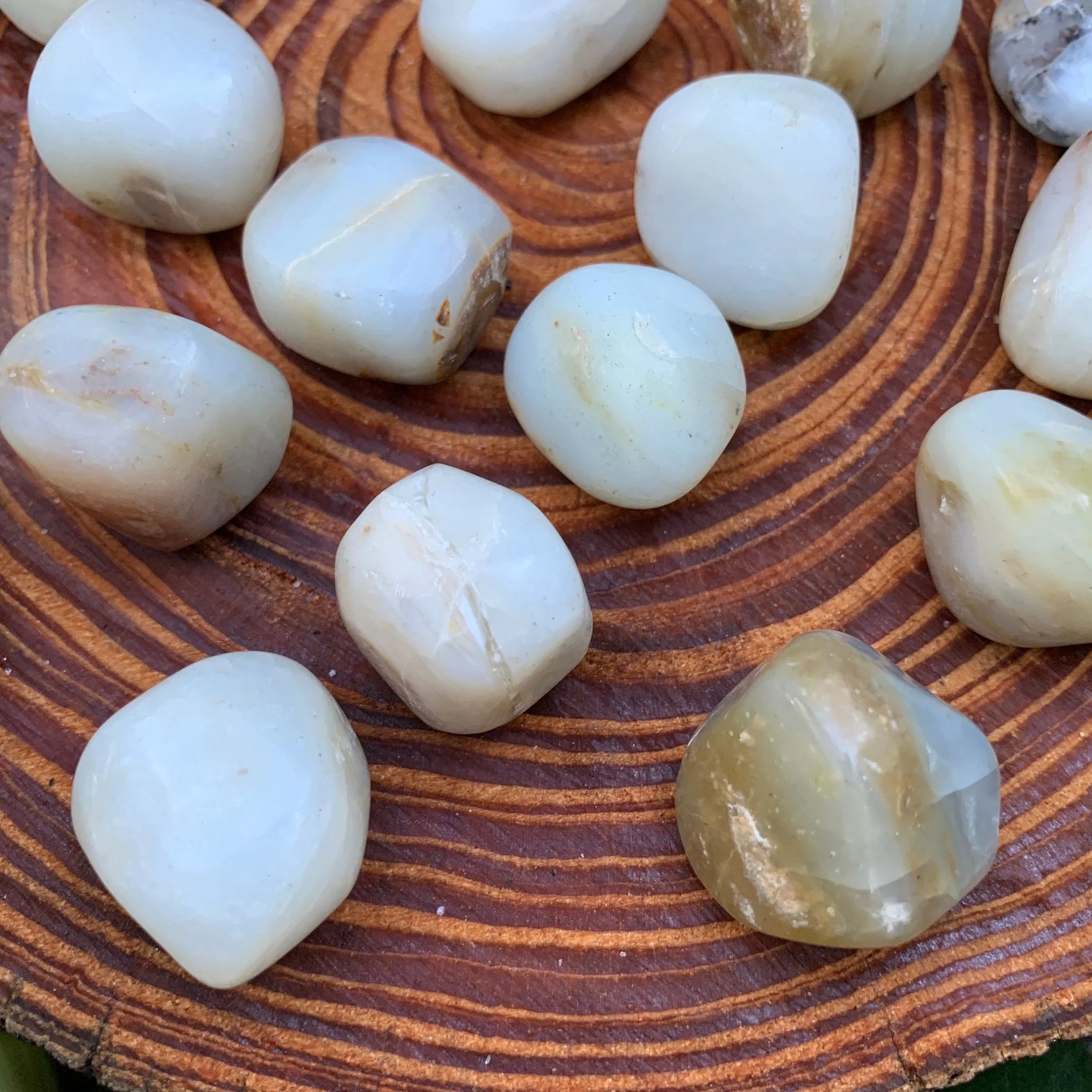 Detail shot of Grade A Blue Opal tumbled stone under natural light