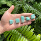 In-hand view of one Amazonite tumbled stone for scale, from Mozambique.