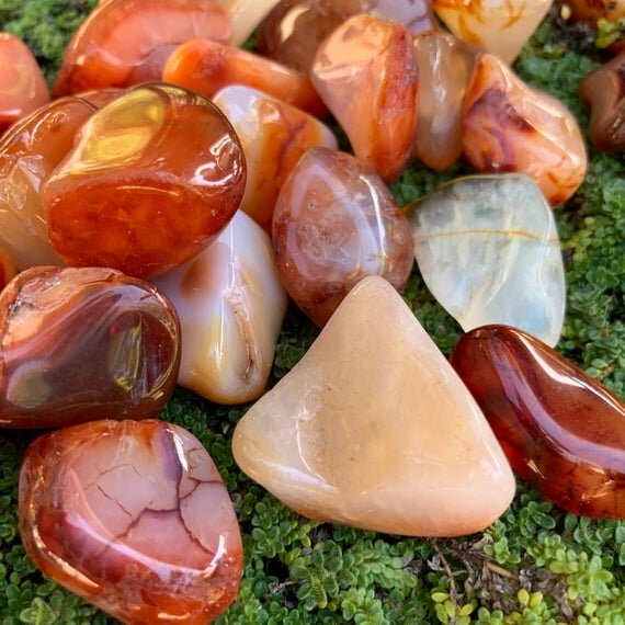 Companion image of Carnelian tumbled stone, from Boeny, Madagascar, with natural details visible.