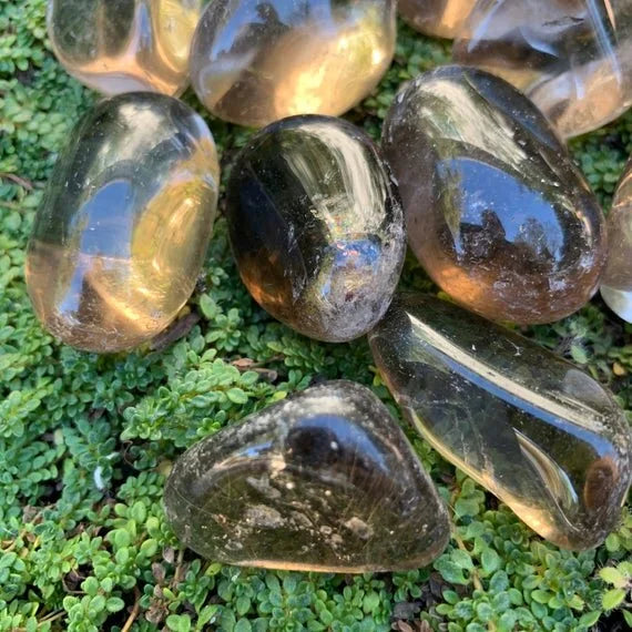 Resting display of Smoky Quartz tumbled stone, from Minas Gerais, Brazil, set to give a sense of weight.