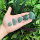 Hand-scale shot of a single Aventurine tumbled stone from Minas Gerais, Brazil.