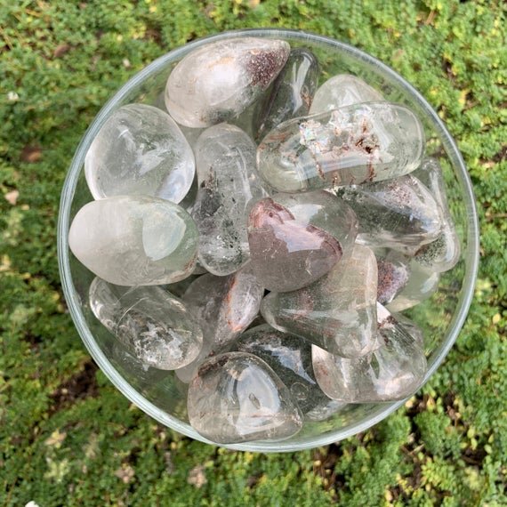 Held in hand, a Lodolite tumbled stone traditionally used for Dreaming.