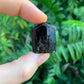 Detail shot of Grade AA Black Tourmaline raw under natural light