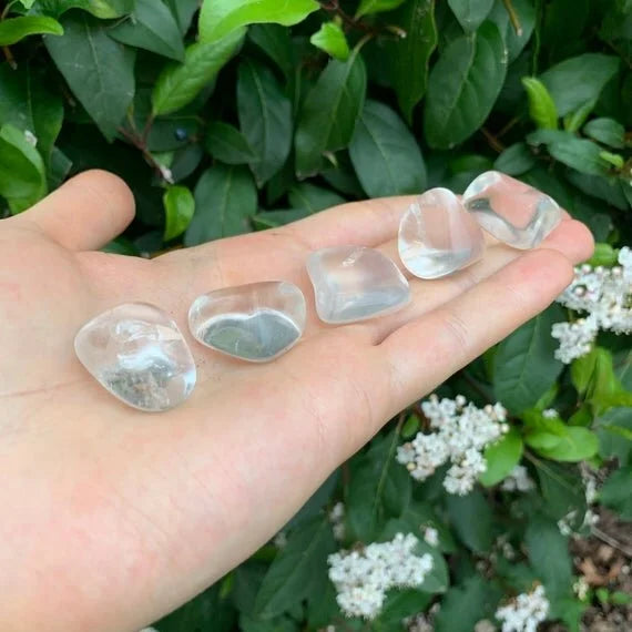 Detail shot of Grade AAA Clear Quartz tumbled stone under natural light