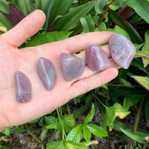 Edge view of Blue Rose Quartz tumbled stone, sourced from Alaotra-Mangoro, Madagascar, turned to for Stress Relief.