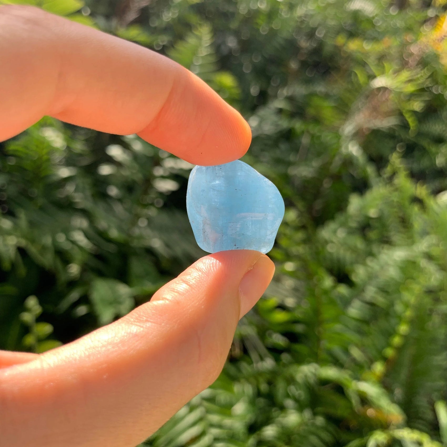 Back view of Grade AAA Aquamarine tumbled stone showing natural surface