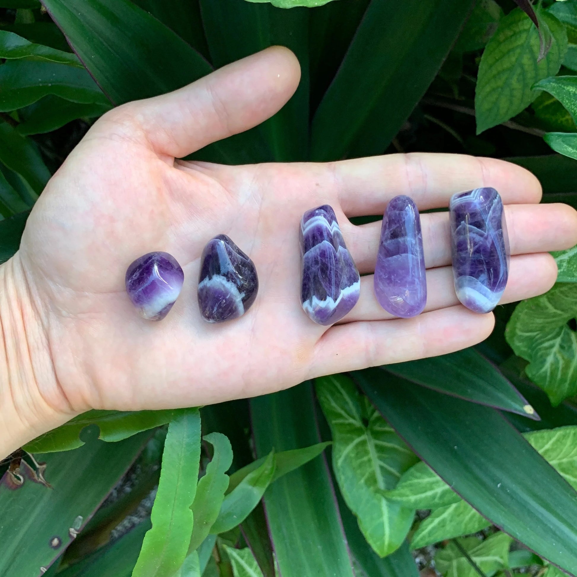 Back view of Grade AA Chevron Amethyst tumbled stone showing natural surface