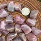 Side perspective of Grade AAA Blue Rose Quartz tumbled stone, hand-selected from Alaotra-Mangoro, Madagascar.