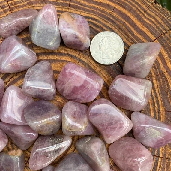 Side perspective of Grade AAA Blue Rose Quartz tumbled stone, hand-selected from Alaotra-Mangoro, Madagascar.