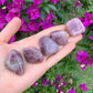 Grain detail of Blue Rose Quartz tumbled stone, from Alaotra-Mangoro, Madagascar, showing earthy tone.