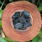 Close detail of Grade AA Black Tourmaline raw stone, kept near for Protection and Grounding, from Brazil.