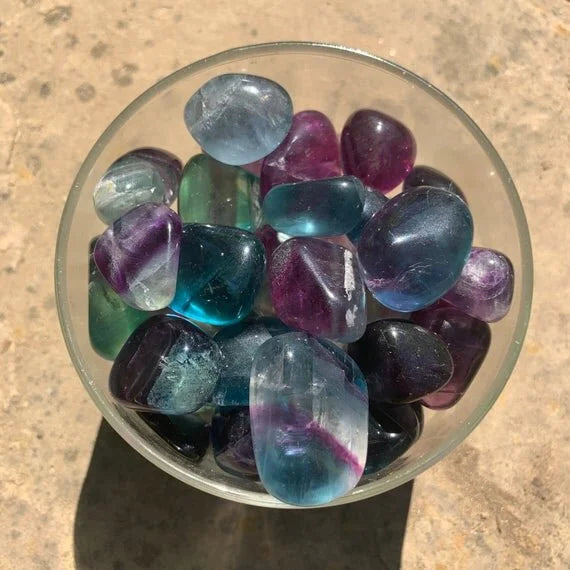 Detail shot of Grade AAA Fluorite tumbled stone under natural light