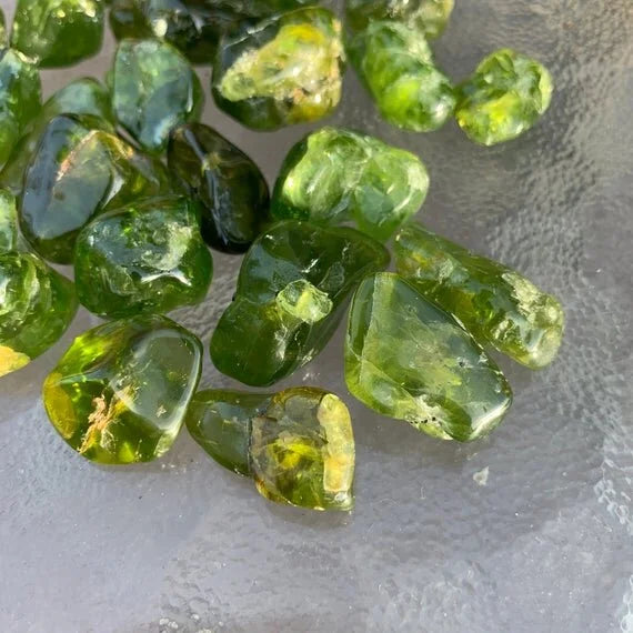 Underside detail of Peridot tumbled stone, showing glassy finish.