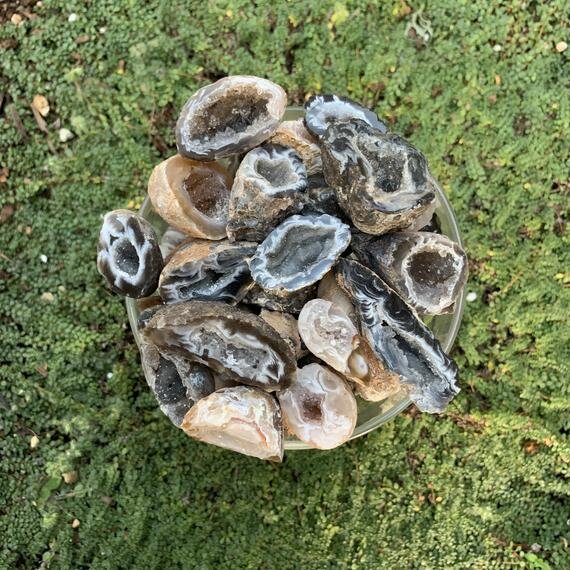Grade aa agate geode held in hand for size reference